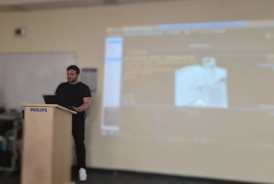 Lior standing showcasing the results of the hackaton